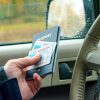 Man in car providing passport and identification at customs checkpoint